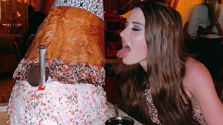 girl licking giant ice cream cone