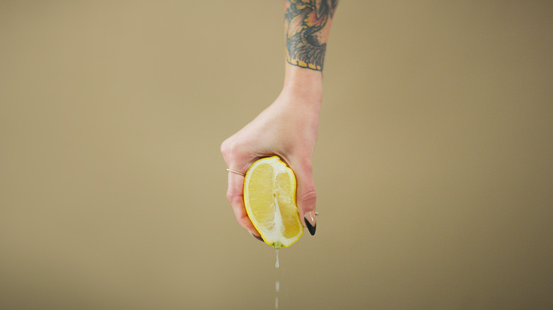 person squeezing lemon juice