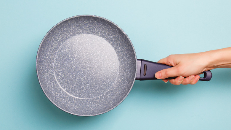 person holding nonstick pan