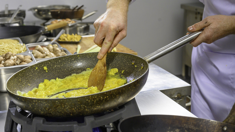 stirring eggs in pan