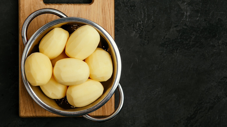 peeled potatoes in colander