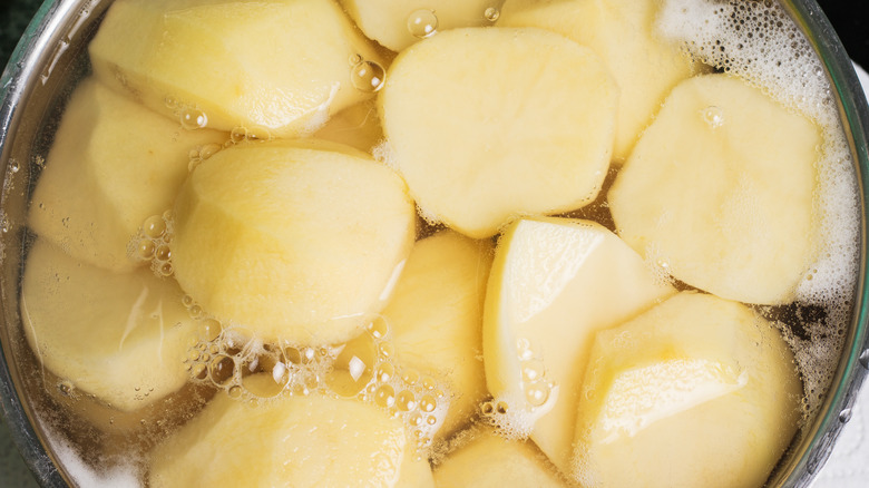 peeled potatoes in boiling water