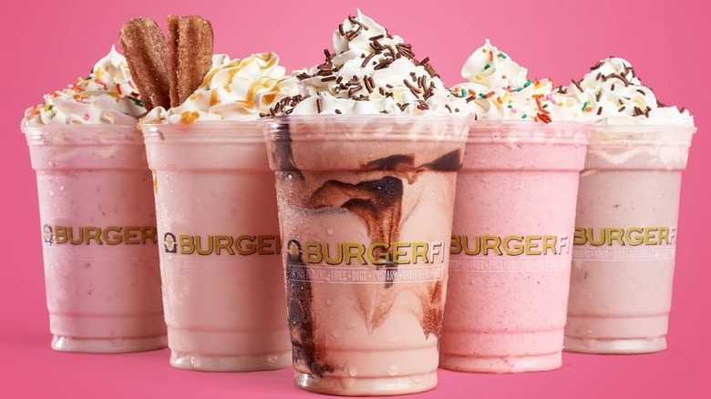  Row of BurgerFi milkshakes on pink background