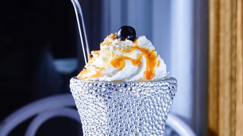 Vanilla milkshake with gold leaf in crystal glass