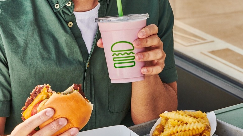 Person holding shake and burger from Shake Shack