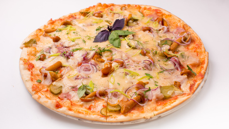 Pizza with pickles and mushrooms