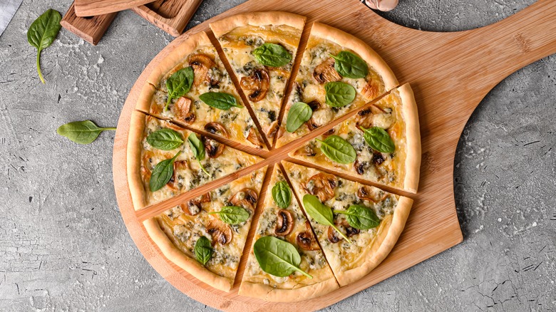 Mushroom pizza with fresh spinach