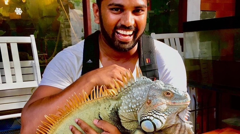 Man holding iguana Vietnamese cafe