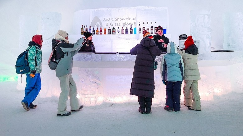 Customers at bar made of ice