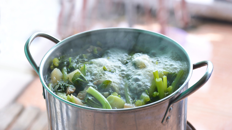 boiling pot filled with green vegetables