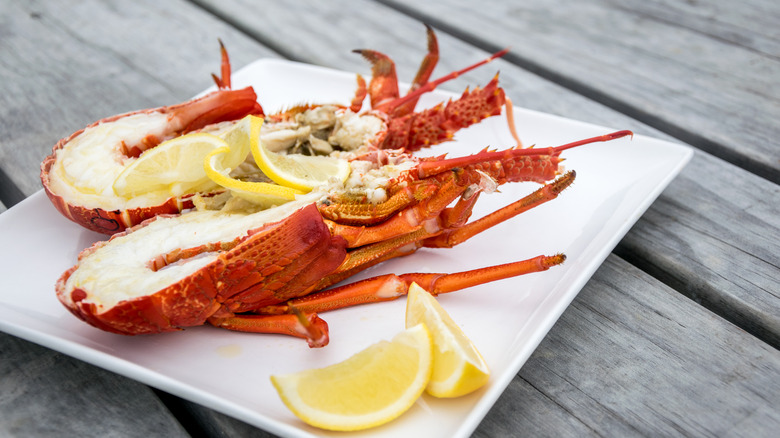 crayfish cut in half with lemon wedges