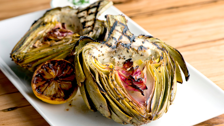 grilled artichokes and lemon on a plate