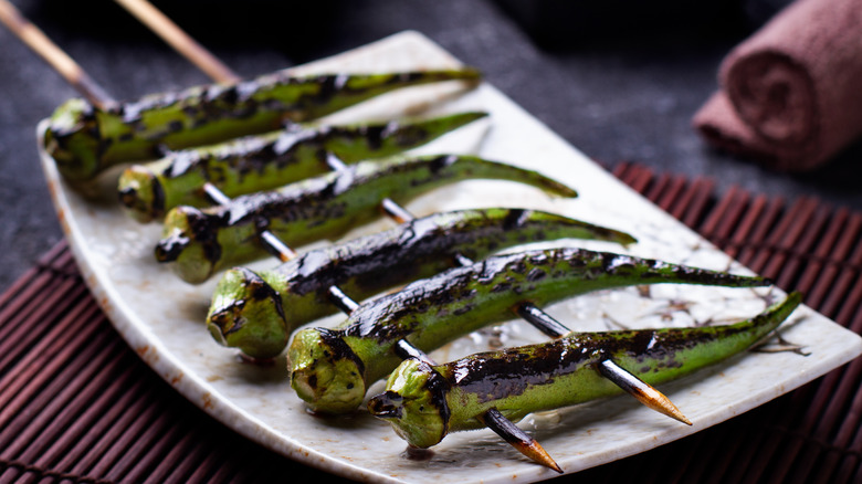 grilled and skewered okra on a plate