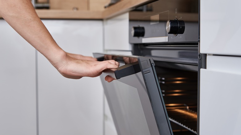 man opening oven door