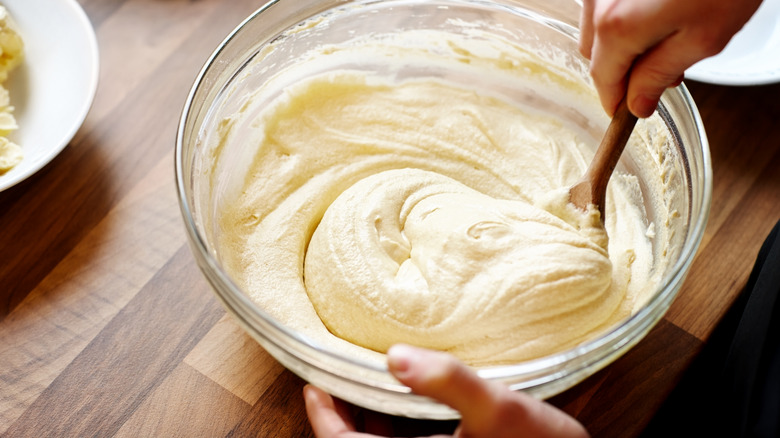 woman mixing muffin batter in bowl