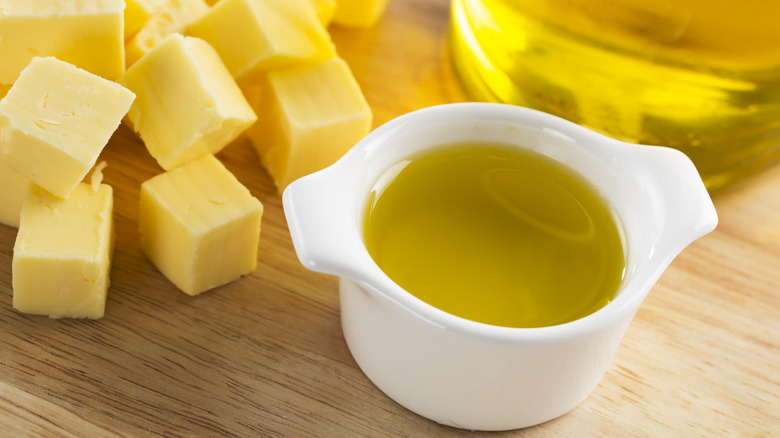 butter and olive oil on a wooden board