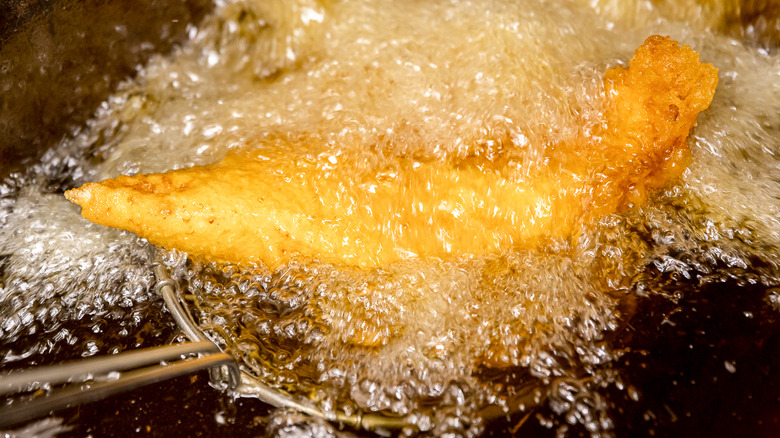 food surrounded by bubbling oil in a deep fryer