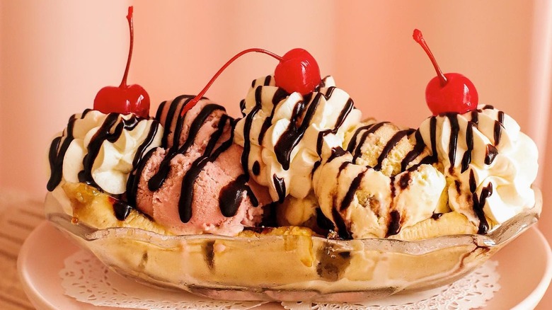 Banana topped with ice cream and cherries