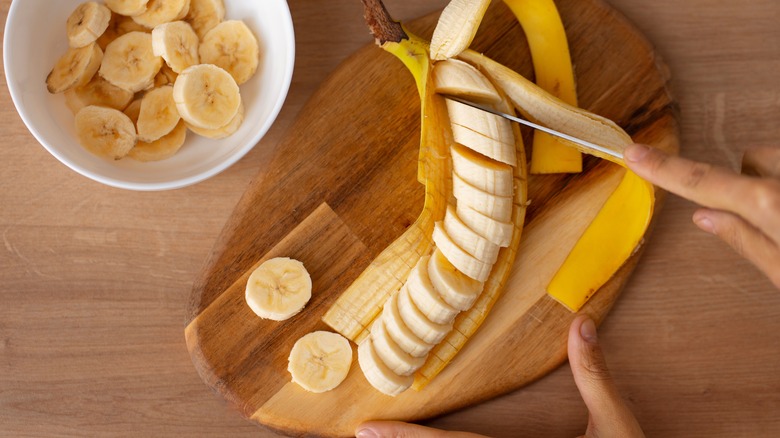 person chopping banana