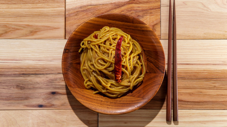 peanut noodles in wooden bowl