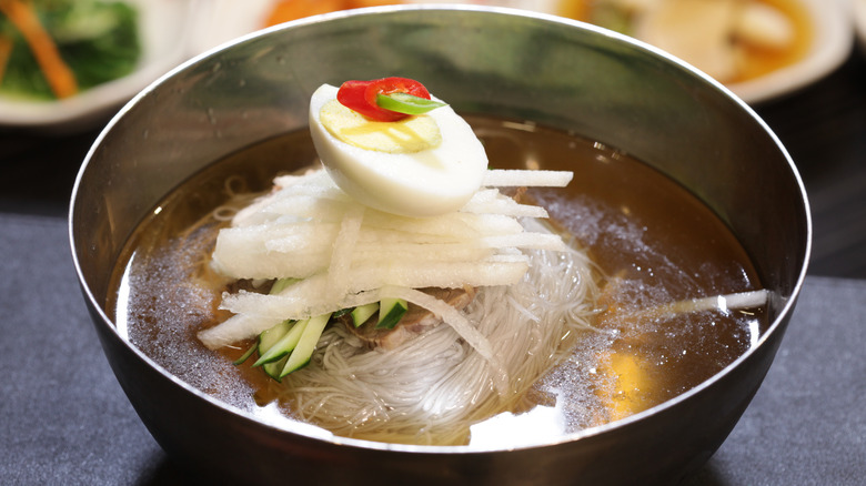 Noodle soup in a silver bowl