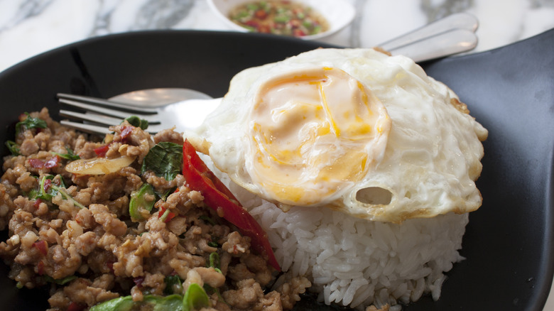 close up of pad krapow with fried egg