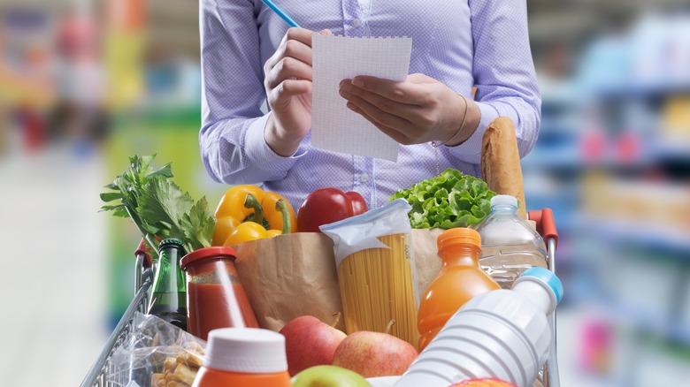 a woman checking a shopping list