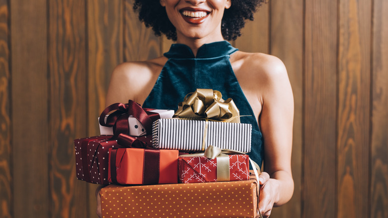 a woman holding presents