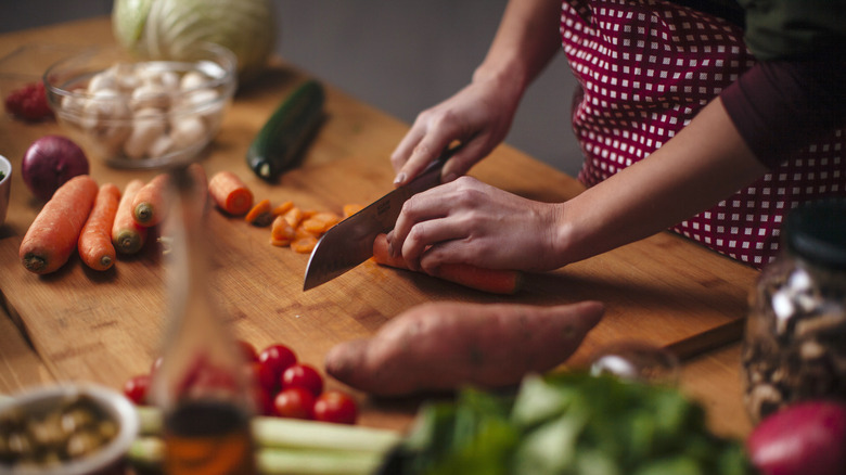 a woman chopping vegetables