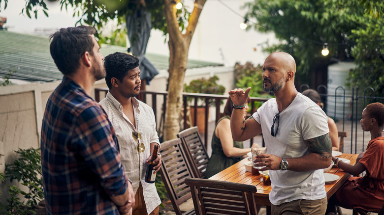 a man talking to friends