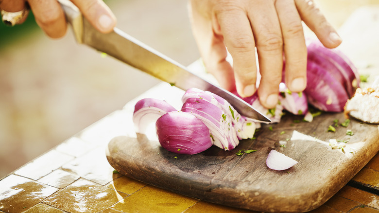 chopping onions on cutting board