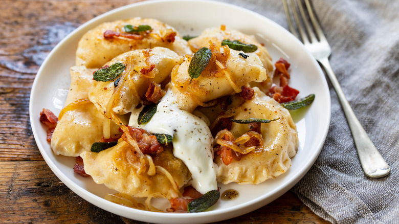 Pierogi with sour cream, bacon, onions, and sage.