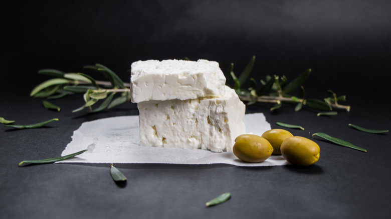 feta cheese and olives black background