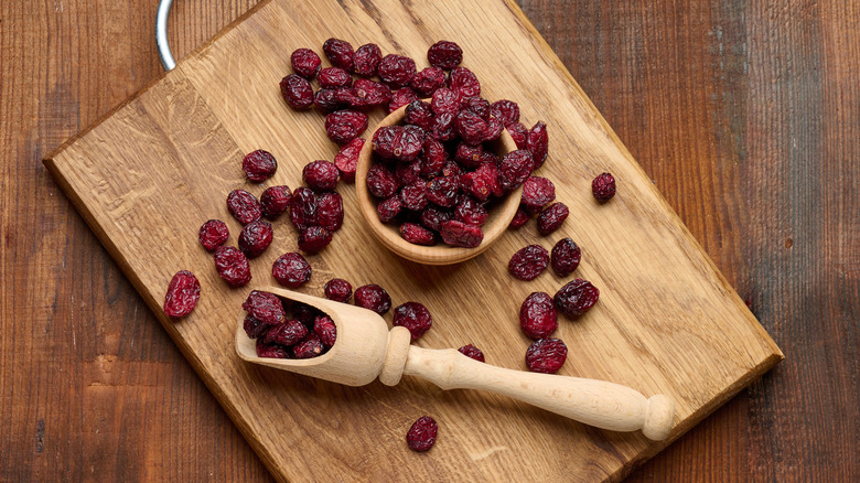 Dried cranberries on a wooden board.