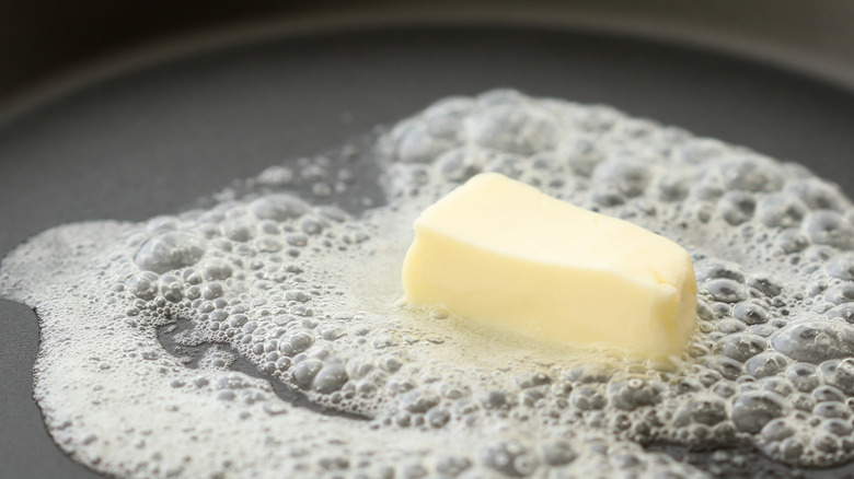 Closeup of butter melting in a frying pan