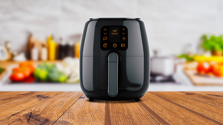 An air fryer sits on a kitchen counter