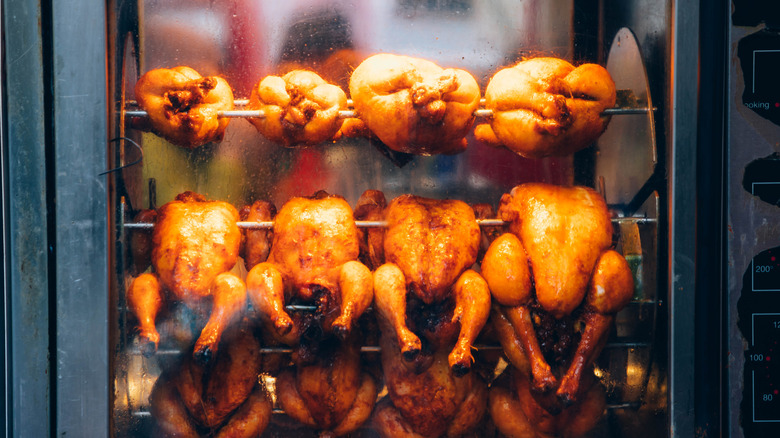 Chickens cooking in a rotisserie oven
