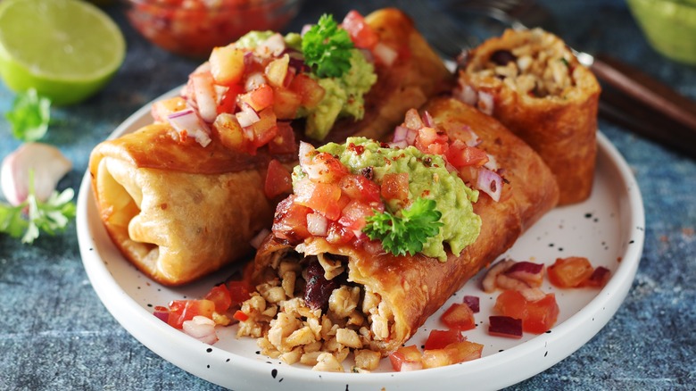 Chicken chimichangas on white plate