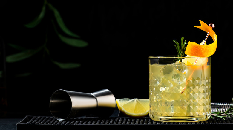 Penicillin cocktail with orange twist and rosemary