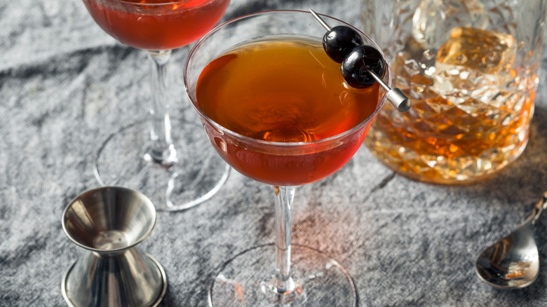 Rob Roy cocktail served in martini glass with cherries