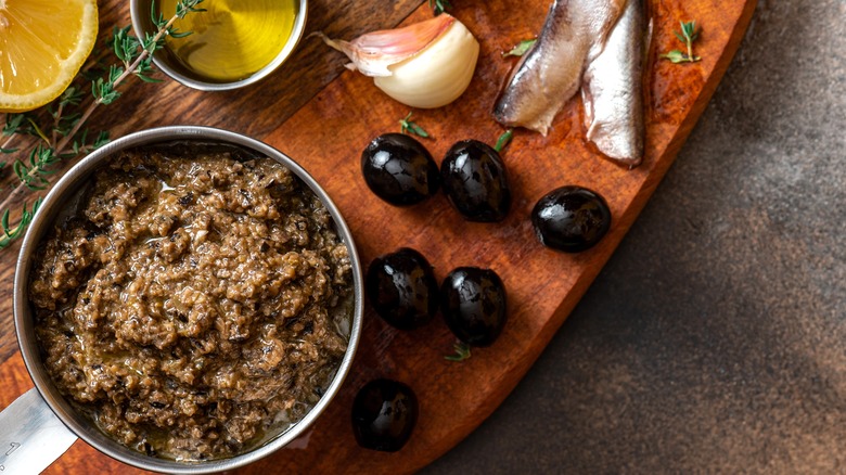 bowl of tapenade with lemon, garlic, anchovies, and black olives