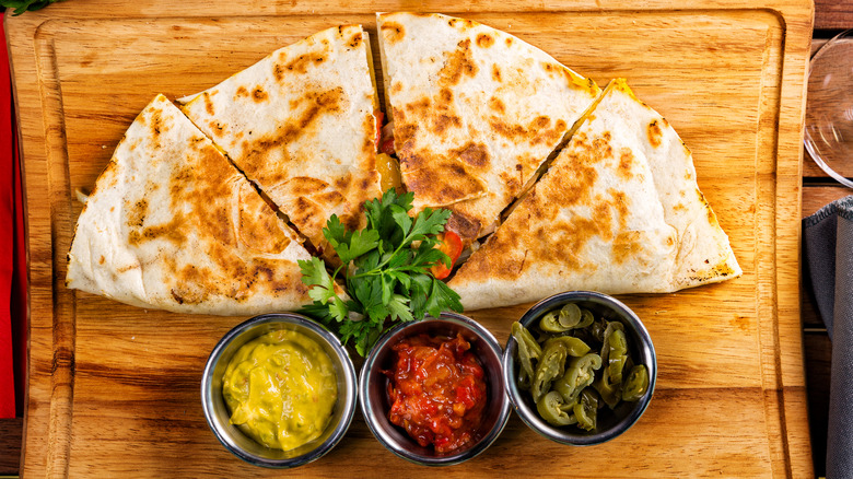 Sliced quesadilla with sauces