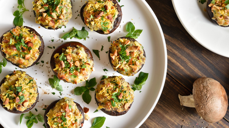 Plate of stuffed mushrooms on a wooden table