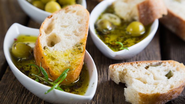 Trays of olive oil with bread dipped in.