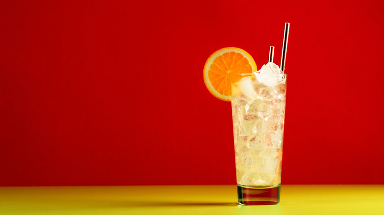 Summer Collins cocktail garnished with an orange wheel