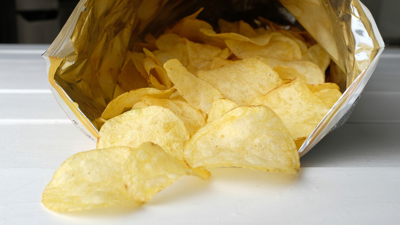 An open bag of potato chips on a white surface