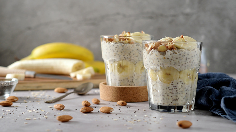 Overnight oats with banans, nuts, and chia seeds in glasses