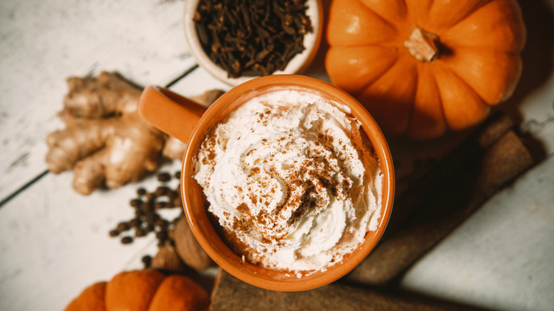 top view of pumpkin spice latte next to gourd