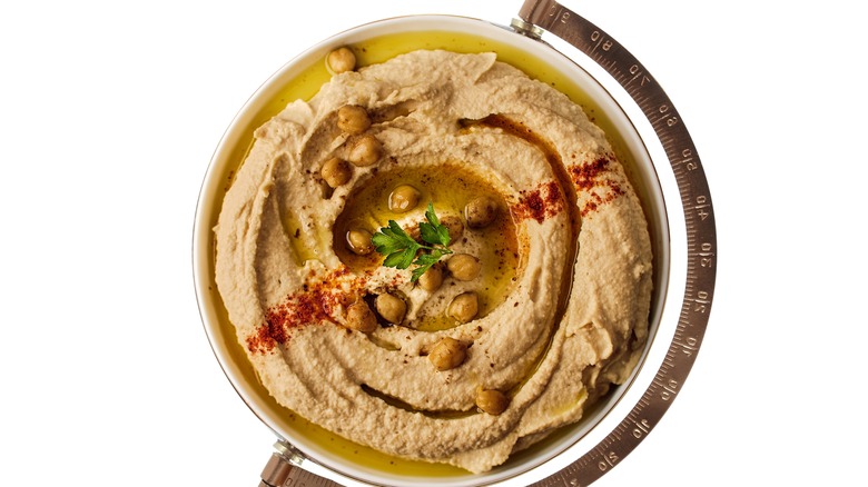 Bowl of hummus with globe stand