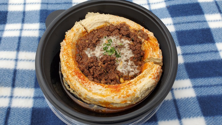 Hummus topped with seasoned ground meat